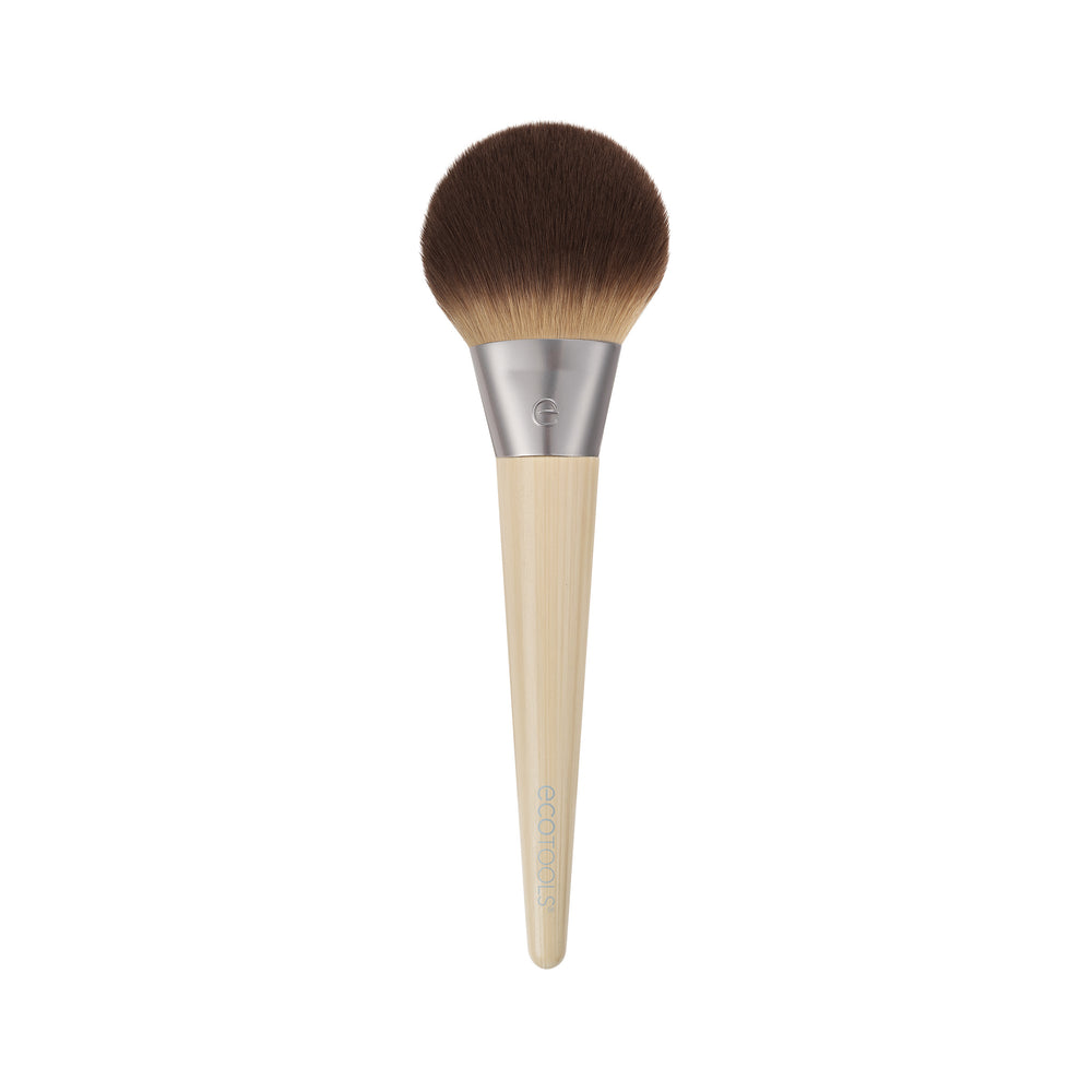 Powder blurring brush with rounded dark brown bristles and light bamboo handle