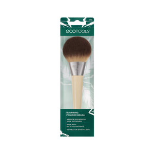 Powder blurring brush shown in retail packaging with round dark bristle head and handle