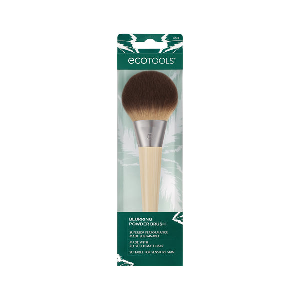 Powder blurring brush shown in retail packaging with round dark bristle head and handle
