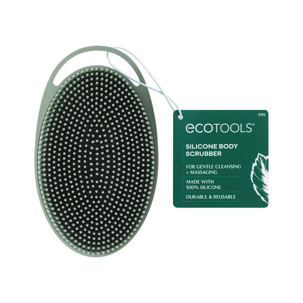 Sage green silicone body scrubber with bristle-textured surface and curved grip base