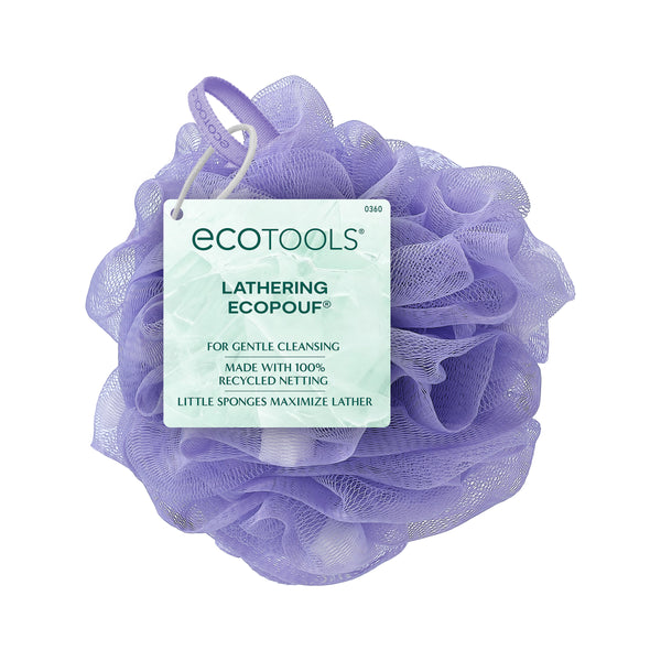 Purple scrubbing pouf with loop handle and label on the front
