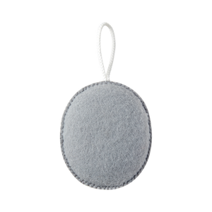 Grey oval exfoliating puff with hanging cord, textured scrubbing surface