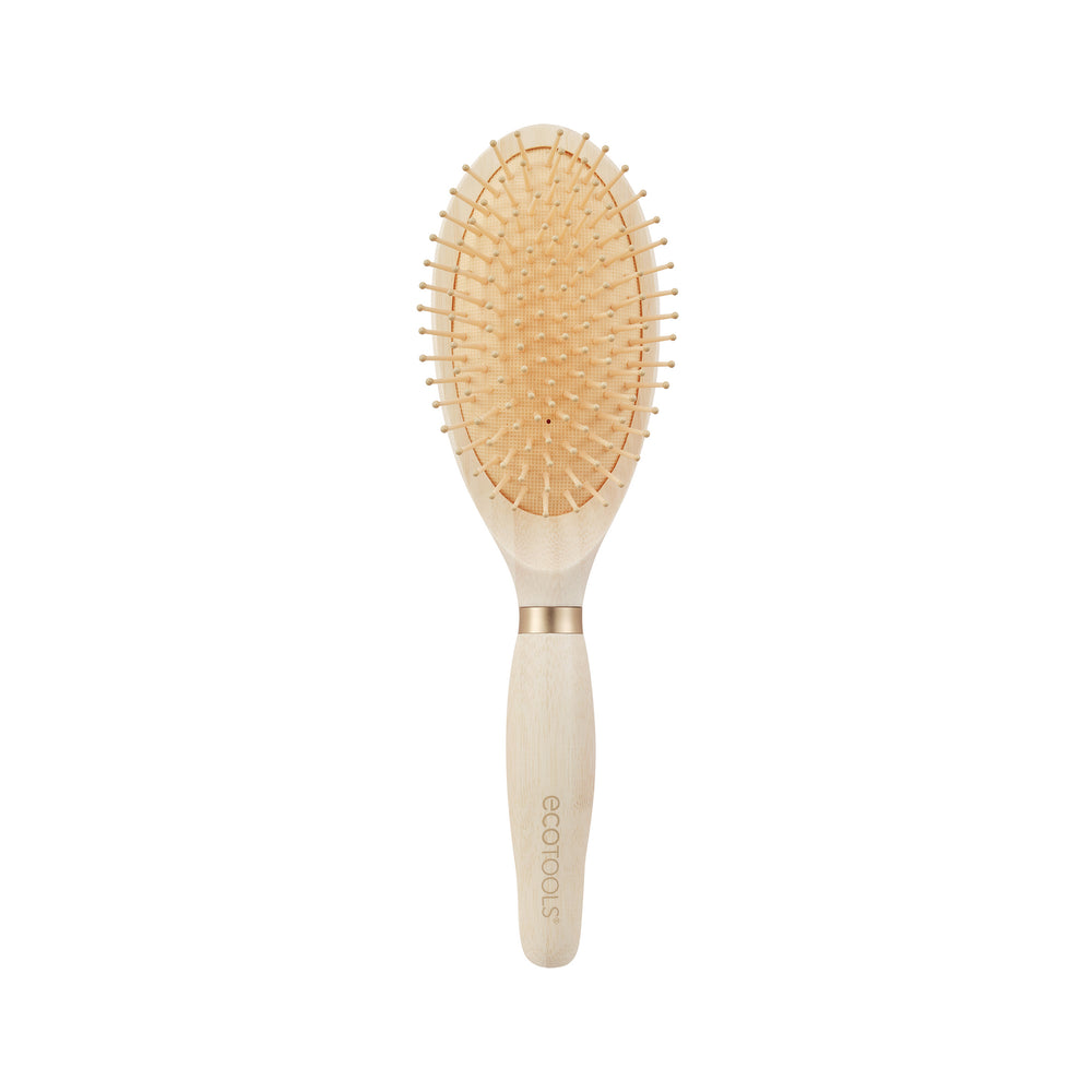 Oval paddle detangling hair brush with tan pins and a light wood grip handle