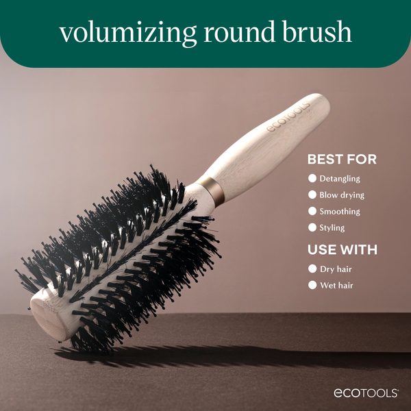 Volumizing round hair brush with light wooden handle and dense black bristle head