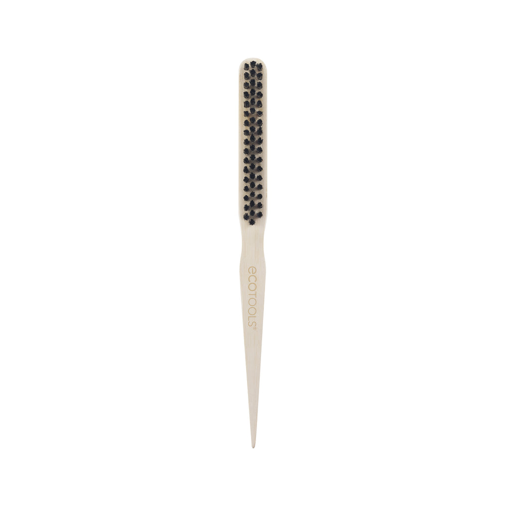 Slick back brush top view with small rounded black bristle tips on cream base