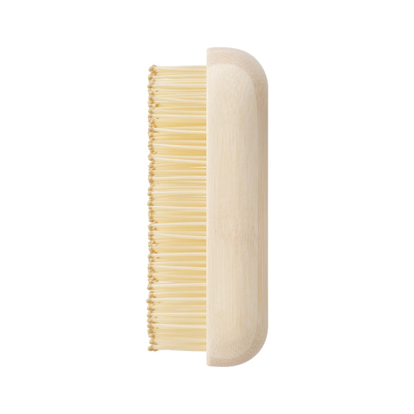 Light tan side view travel detangling brush with dense bamboo bristle rows