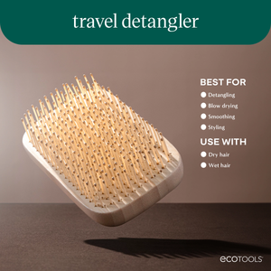 Travel detangler hairbrush with cushioned paddle base and light wooden bristles