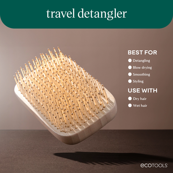 Travel detangler hairbrush with cushioned paddle base and light wooden bristles