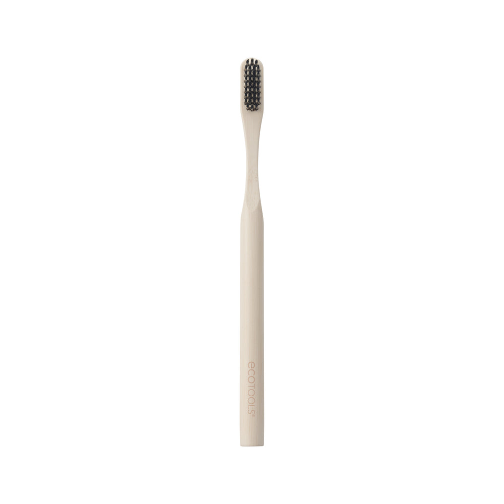 Edge defining brush with light bamboo handle and dark bristles, front view