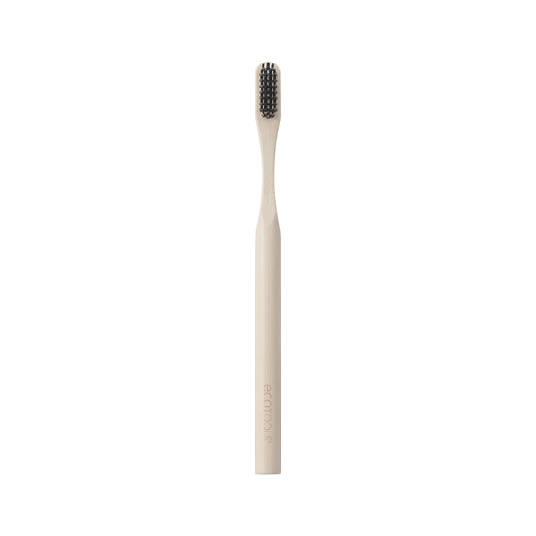 Edge defining brush with light bamboo handle and dark bristles, front view