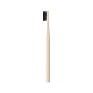 Edge defining brush with light handle and dark bristle head, top view