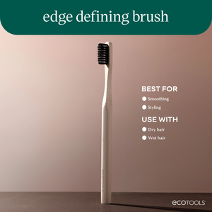 Edge defining brush with light bamboo handle and dark bristles, angled side view