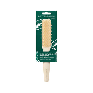 Green front product box featuring a light wood detangling brush with gold bristles