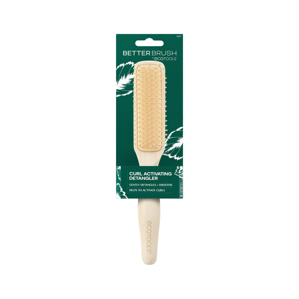 Green front product box featuring a light wood detangling brush with gold bristles