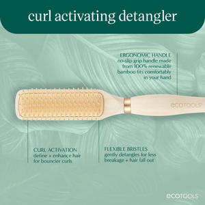 Long-handled detangling brush with light wood body and gold flexible bristles