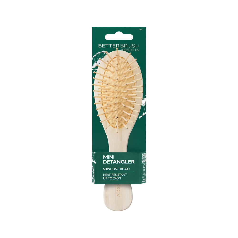 Mini detangler hair brush with oval wooden pad and light bamboo handle