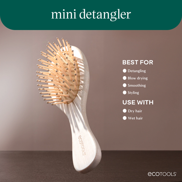 Mini detangler hair brush marketing image with oval pin head and wooden handle