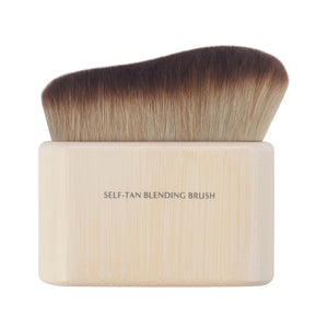 Self-tan blending brush with dense angled bristles and light bamboo handle