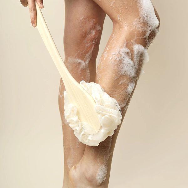 Ivory bath brush on bamboo handle for scrubbing wet skin