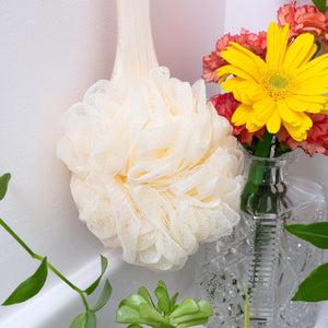 Ivory loofah bath brush with ruffled flower head on bamboo handle