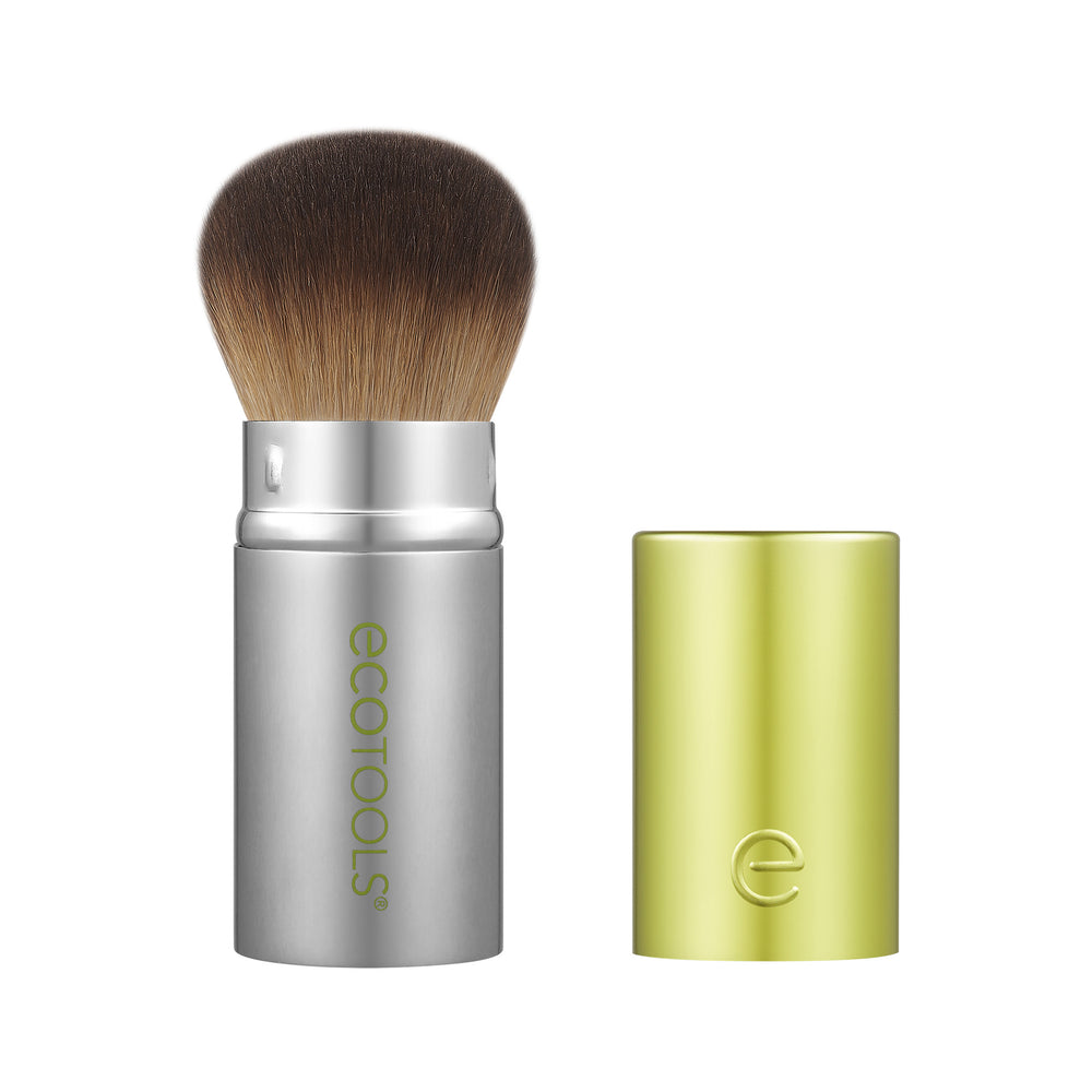 Retractable face brush with silver handle, brown bristles, and lime cap
