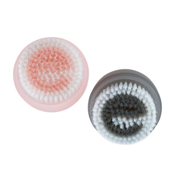 Two round brush heads with pink and gray bases and textured bristle surfaces