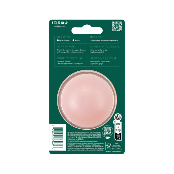 Packaged facial cleansing brush with pink round brush head in blister on green card