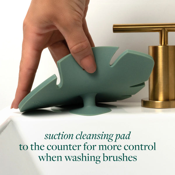 Suction makeup brush cleansing pad, teal silicone with raised bristle nubs