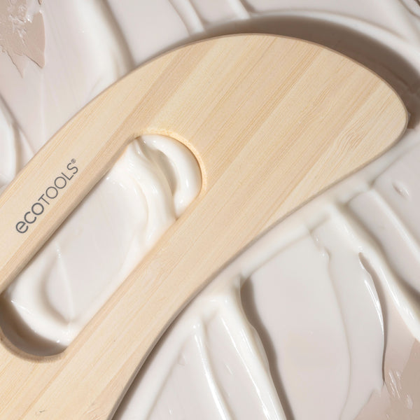 Close-up of bamboo wooden body massager oval cutout and smooth surface, ecotools mark.