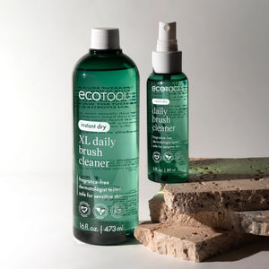 XL and regular brush cleaner bottles with white sprayers, dark green bottles.