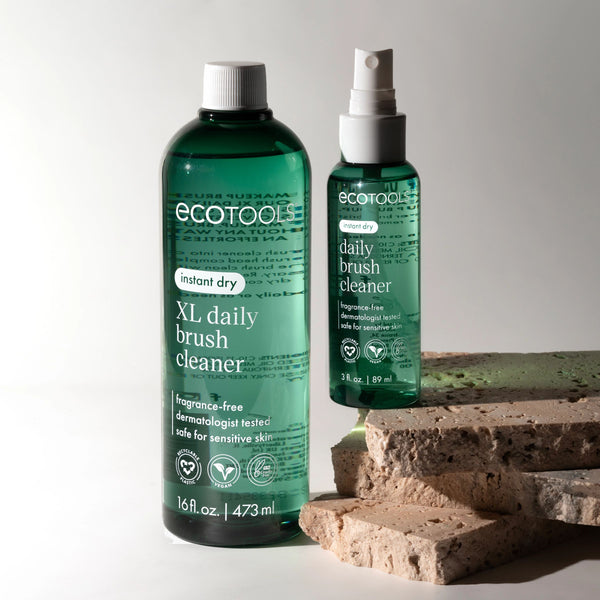 XL and regular brush cleaner bottles with white sprayers, dark green bottles.
