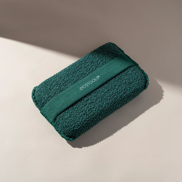 Rolled dark green XL Body Buffer scrub cloth with hanging strap