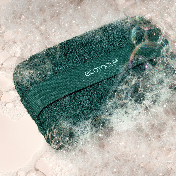 Dark green XL Body Buffer scrub cloth with foamy lather, strap visible
