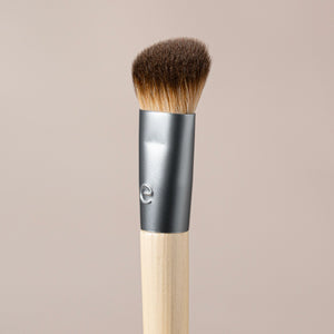 Precision concealer brush close-up with dense brown bristles and silver ferrule
