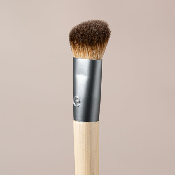Precision concealer brush close-up with dense brown bristles and silver ferrule
