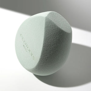 Light green makeup blurring blender sponge, close-up side view with fine texture