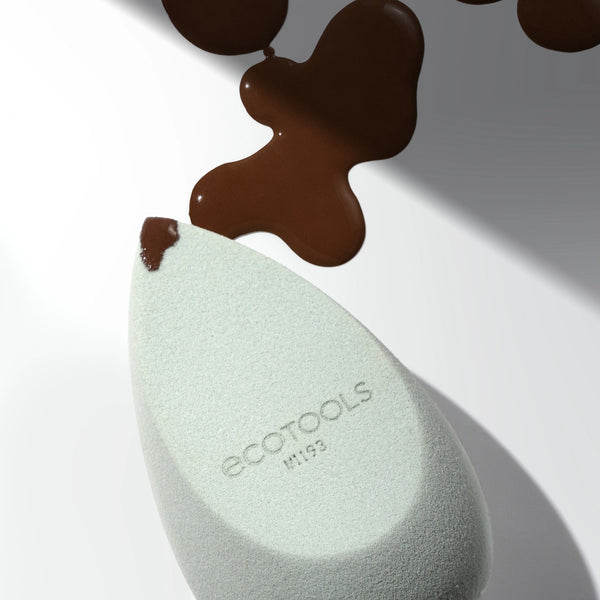 Light green makeup blurring blender sponge with dark brown smudges above
