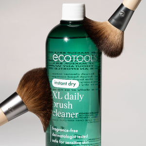 Green XL daily brush cleaner bottle with overflowing close-up brush heads.