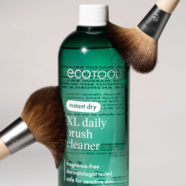 Green XL daily brush cleaner bottle with overflowing close-up brush heads.