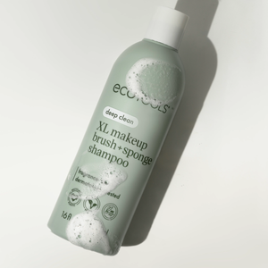Sage-green ECOTools shampoo bottle with foam bubbles, deep clean XL label