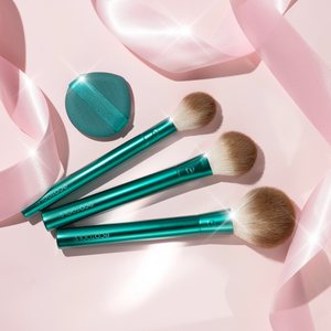 Makeup brushes with teal round puff and compact in a gift set layout