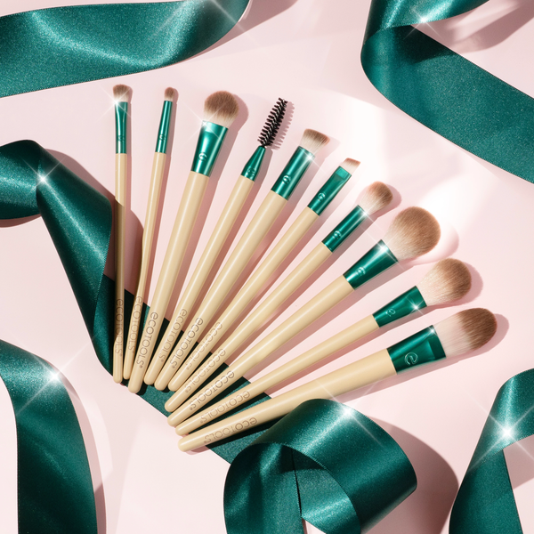 10-piece makeup brush set arranged on a flat surface with teal ferrules and cream handles