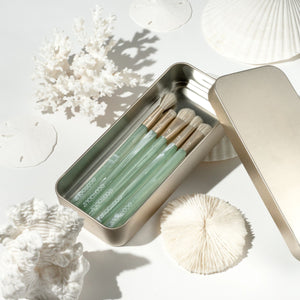 Sea Gems brush tin open with five brushes and a white cleansing puff beside them
