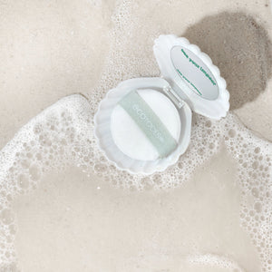 White pearl puff in scalloped case with green logo label