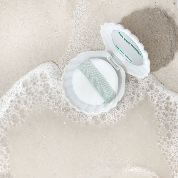 White pearl puff in scalloped case with green logo label