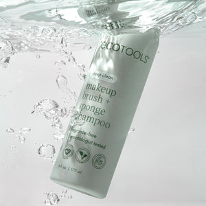 Makeup brush + sponge shampoo bottle in water splash, light green liquid