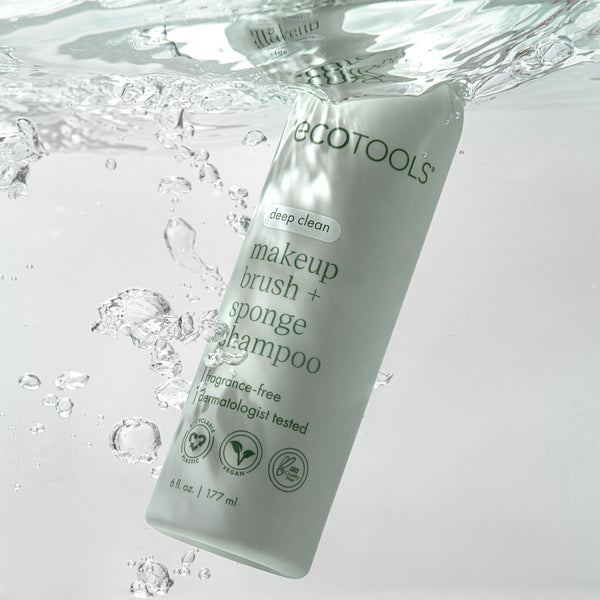 Makeup brush + sponge shampoo bottle in water splash, light green liquid