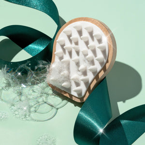 Wood scalp massager with white rubber-tipped spikes for stimulating scalp massage