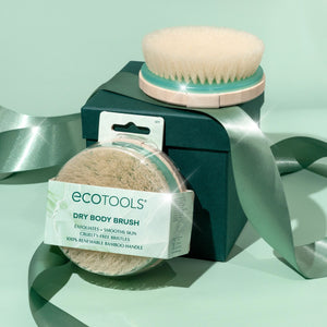 Dry body brush with beige bristle head and teal-sided handle, shown in retail box