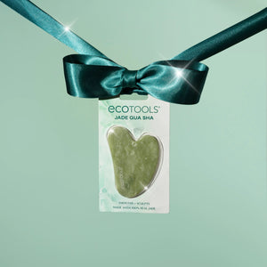 Jade gua sha tool in clear retail packaging with teal bow